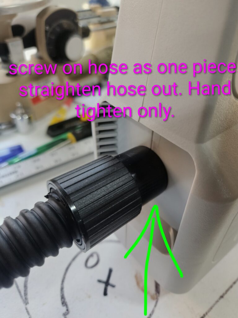 Black ribbed hose connector attached to machine